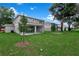 View of two story home from large grassy back yard at 3741 Deer Ridge Dr, Mount Dora, FL 32757
