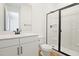 Bathroom with modern black hardware, shower with glass door, and wood look tile floors at 3741 Deer Ridge Dr, Mount Dora, FL 32757