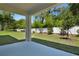 Covered patio overlooks a lush backyard with a white fence and mature trees at 3749 Deer Ridge Dr, Mount Dora, FL 32757