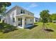 A beautiful home featuring a covered patio and well-maintained backyard with a vibrant green lawn at 3749 Deer Ridge Dr, Mount Dora, FL 32757