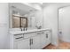 Modern bathroom with double sinks, sleek black fixtures, and a large mirror at 3749 Deer Ridge Dr, Mount Dora, FL 32757