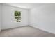 Bright bedroom with a large window showcasing a leafy neighborhood at 3749 Deer Ridge Dr, Mount Dora, FL 32757