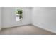 Cozy bedroom with a view of lush trees through a single window at 3749 Deer Ridge Dr, Mount Dora, FL 32757