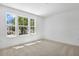 An airy bedroom is brightened by three large windows overlooking a tree-lined street at 3749 Deer Ridge Dr, Mount Dora, FL 32757
