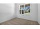 Cozy bedroom with neutral carpet and a large window overlooking the neighborhood at 3749 Deer Ridge Dr, Mount Dora, FL 32757