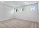 A bright, carpeted bedroom with three windows provides plenty of natural light at 3749 Deer Ridge Dr, Mount Dora, FL 32757