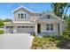 Inviting two-story home with a three-car garage and manicured landscaping under a clear blue sky at 3749 Deer Ridge Dr, Mount Dora, FL 32757