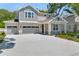 Attractive two-story home with a three-car garage, spacious driveway, and lush landscaping at 3749 Deer Ridge Dr, Mount Dora, FL 32757