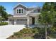 Charming two-story home with a three-car garage, landscaped yard, and stone accents at 3749 Deer Ridge Dr, Mount Dora, FL 32757