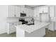Modern kitchen featuring white cabinets, stainless steel appliances, and a center island at 3749 Deer Ridge Dr, Mount Dora, FL 32757