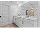 Bright bathroom featuring a double sink vanity with modern fixtures and a large mirror at 3757 Deer Ridge Dr, Mount Dora, FL 32757