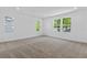 Neutral bedroom features soft carpeting and large windows offering plenty of natural light at 3757 Deer Ridge Dr, Mount Dora, FL 32757