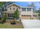 Charming two-story home featuring mixed siding, stone accents, a well-manicured lawn, and a two-car garage at 3757 Deer Ridge Dr, Mount Dora, FL 32757