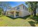 Back exterior view of a two-story home featuring a covered patio and spacious backyard with trees at 3757 Deer Ridge Dr, Mount Dora, FL 32757