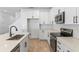 Bright kitchen with white cabinets, stainless steel appliances, a center island, and wood-look flooring at 3757 Deer Ridge Dr, Mount Dora, FL 32757
