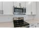 Close up view of white quartz countertops and stainless steel appliances at 3757 Deer Ridge Dr, Mount Dora, FL 32757