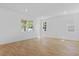 Bright and airy living room with wood-look flooring and ample natural light from multiple windows at 3757 Deer Ridge Dr, Mount Dora, FL 32757