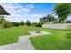 Large backyard featuring a modern stone fire pit, providing a perfect space for outdoor entertaining and relaxation at 4217 Park Lake St, Orlando, FL 32803