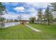 Expansive backyard leading to a serene lake with a charming wooden bridge and a well-maintained fence at 4217 Park Lake St, Orlando, FL 32803