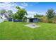 Large backyard features lush green grass and a convenient fire pit at 4217 Park Lake St, Orlando, FL 32803