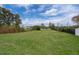 Spacious backyard with a view of the water, secured by black metal fencing on a sprawling green lawn at 4217 Park Lake St, Orlando, FL 32803