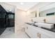 This bathroom features double sinks, black granite counters, and a walk in shower at 4217 Park Lake St, Orlando, FL 32803