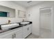 Bathroom features double sinks with granite countertops, gold hardware, and a view of a large walk-in closet at 4217 Park Lake St, Orlando, FL 32803