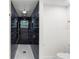 Modern bathroom featuring an elegant black marble tiled shower with gold fixtures and hardware at 4217 Park Lake St, Orlando, FL 32803
