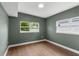 Cozy bedroom with wood floors and two windows providing natural light at 4217 Park Lake St, Orlando, FL 32803