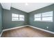 This bedroom has great natural light, wood floors, and calming gray-green walls at 4217 Park Lake St, Orlando, FL 32803