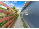 Side view of the house featuring a brick walkway, and wooden privacy fence at 4217 Park Lake St, Orlando, FL 32803