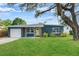 Charming home with vibrant blue exterior, stone accents, and a bright yellow front door at 4217 Park Lake St, Orlando, FL 32803