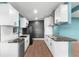 Modern kitchen featuring white cabinets, stainless appliances, and stylish black marble countertops at 4217 Park Lake St, Orlando, FL 32803