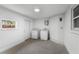 Clean and simple laundry room featuring a washer, dryer, storage cabinet, and a window at 4217 Park Lake St, Orlando, FL 32803