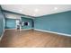 Open living space featuring hardwood floors, ample natural light, and a view of the adjacent kitchen area at 4217 Park Lake St, Orlando, FL 32803