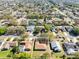 House aerial view showing well-kept lawns, mature trees, and a quiet residential street at 4222 Gold Rush Ln, St Cloud, FL 34772