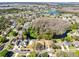 A high aerial view of the house showing proximity to lake, trees, and surrounding neighborhood at 4222 Gold Rush Ln, St Cloud, FL 34772