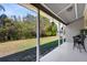 Covered back porch overlooking a spacious backyard with lush greenery and a shaded area at 4222 Gold Rush Ln, St Cloud, FL 34772