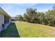 View of backyard with pond, screened in patio and trees at 4222 Gold Rush Ln, St Cloud, FL 34772