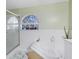 Bright bathroom showcasing a large soaking tub beneath a charming stained glass window, adding unique character at 4222 Gold Rush Ln, St Cloud, FL 34772