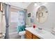 Bright bathroom with a shower-tub combo and a wood vanity with sink at 4222 Gold Rush Ln, St Cloud, FL 34772