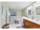 Relaxing bathroom featuring dual sinks, vanity lighting, and a large soaking tub with a window at 4222 Gold Rush Ln, St Cloud, FL 34772