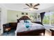 Inviting bedroom featuring a dark wooden bed frame, and a large window for ample natural light at 4222 Gold Rush Ln, St Cloud, FL 34772