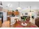 Open dining area with wood laminate flooring and views into kitchen and living area at 4222 Gold Rush Ln, St Cloud, FL 34772