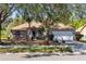 Attractive single-story home featuring a well-kept lawn and mature trees at 4222 Gold Rush Ln, St Cloud, FL 34772