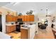 Open kitchen featuring wood cabinets, views into the living room, and wood laminate flooring at 4222 Gold Rush Ln, St Cloud, FL 34772