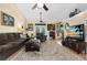 Spacious living room features a plush sofa, ceiling fan, and a large area rug on wood floors at 4222 Gold Rush Ln, St Cloud, FL 34772