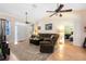 Inviting living room with vaulted ceilings, ceiling fans, comfortable seating and wood laminate flooring at 4222 Gold Rush Ln, St Cloud, FL 34772