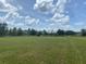 Sprawling backyard offers ample space for recreation and outdoor activities under a bright sky at 4261 Twilight Trl, Kissimmee, FL 34746