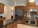 Stylish kitchen featuring stainless steel appliances, rich wood cabinets, and a large island at 4261 Twilight Trl, Kissimmee, FL 34746